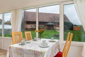 a table with a vase of flowers on top of it at Haus Nussbaum in Hödingen +11 photos