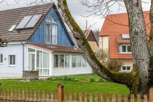 a house with a blue roof with windows at Haus Nussbaum in Hödingen