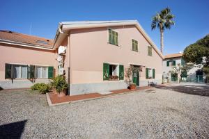 a house with a gravel driveway in front of it at Appartamento Orizzonte 8 B in Diano Marina