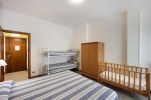 a small room with a bed and a closet at Appartamento Orizzonte 8 B in Diano Marina