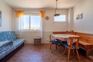 a living room with a table and a couch at Grand Hotel Studio in Valras-Plage