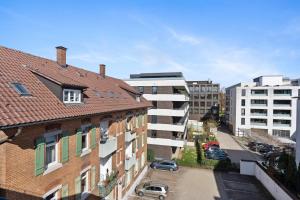 an aerial view of a city with buildings and cars at Apartment Lio - See und Zentrum in Friedrichshafen