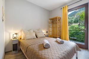 a bedroom with a bed and a large window at New Casa Di Tino in Brenzone sul Garda
