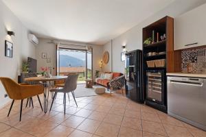 a kitchen and living room with a table and chairs at New Casa Di Tino in Brenzone sul Garda