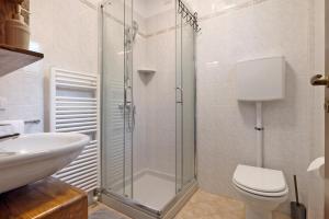 a bathroom with a shower and a toilet and a sink at New Casa Di Tino in Brenzone sul Garda +17 photos