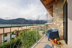 a balcony with a view of the water and mountains at New Casa Di Tino in Brenzone sul Garda