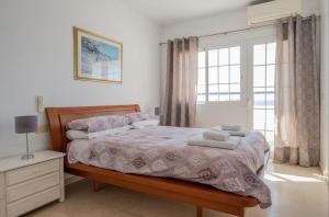 a bedroom with a bed and a window at Flat3-5 Chaparil Beach in Nerja +18 photos