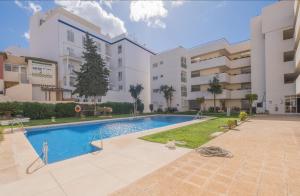 an apartment with a swimming pool in a building at Flat3-5 Chaparil Beach in Nerja