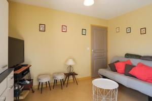 a living room with a couch and a flat screen tv at Gîte Proche Mer 800 m in Plouézec