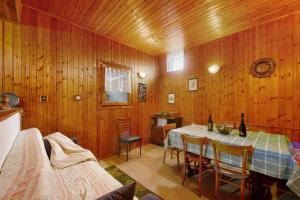 a dining room with a table and chairs and wooden walls at Casa Vacanze Gianluca in Aosta