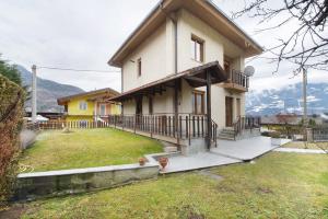 a large house with a porch and a yard at Casa Vacanze Gianluca in Aosta