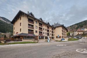 a large building on a street in the mountains at L'Edelweiss in Saint-Pierre-de-Chartreuse