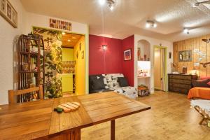 a living room with a wooden table in a room at L'Edelweiss in Saint-Pierre-de-Chartreuse