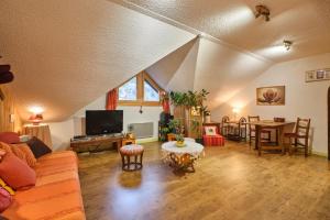 a living room with a couch and a table at L'Edelweiss in Saint-Pierre-de-Chartreuse