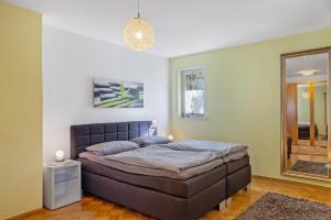 a bedroom with a bed and a mirror at Ferienwohnung Fuldatalblick in Fulda