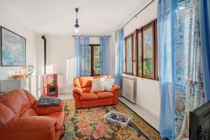 a living room with two chairs and a television at Villa Bella Vista in Imperia