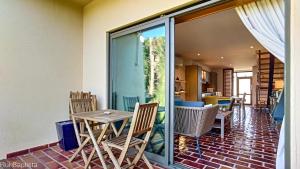 a dining room with a table and chairs on a patio at Arrancada 14 in Pêra