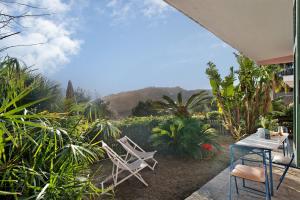 a patio with two chairs and a table at Villa Bella Vista in Imperia
