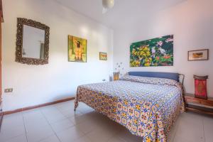 a bedroom with a bed and a mirror on the wall at Jera suite vista mare 2 in Vulcano