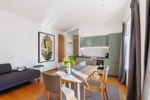 a dining room and kitchen with a table and chairs at Sommavilla Apartments in Silandro +35 photos