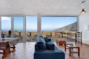 a living room with a blue couch and a table at La Cuadra de Juan in Frontera