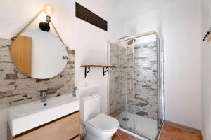 a bathroom with a toilet and a sink and a shower at La Cuadra de Juan in Frontera +20 photos