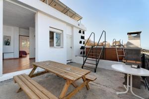 a patio with a wooden bench and a ladder at La Cuadra de Juan in Frontera