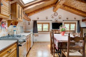 a kitchen with a table and a stove at Casa Sasia in Casteldelfino +14 photos