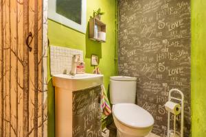 a bathroom with a toilet and a chalkboard wall at Cal Barral in Ansobell +22 photos