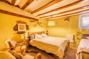 a bedroom with a bed and a chair in it at Cal Barral in Ansobell