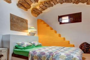 a bedroom with a bed and a stairway at Villa El Cactus in Teguise +36 photos