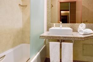 a bathroom with a sink and a bath tub at Dfm Happy Days C - Funchal in Funchal