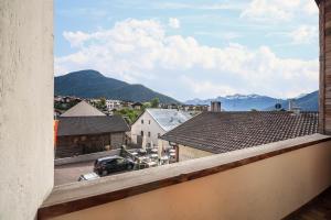 a view from a balcony of a town with mountains at Ferienwohnung Burgeis in Malles Venosta