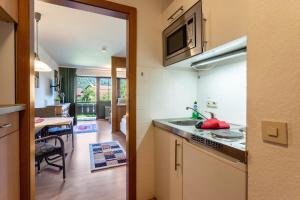 a kitchen with a sink and a microwave at Studio Bergblick in Inzell