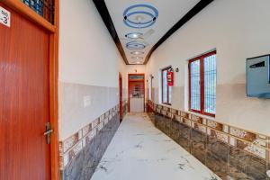 an empty corridor in an office building with a cracked floor at Super Hotel O Raj Ghat Ayodhya Formerly Shree Siya Raman in Ayodhya