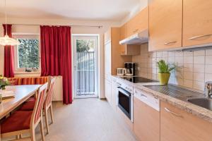 a kitchen with a table and a counter top at Ferienwohnung Helena in Schwendau +17 photos