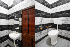 a bathroom with a toilet and a sink at Super Hotel O Raj Ghat Ayodhya Formerly Shree Siya Raman in Ayodhya