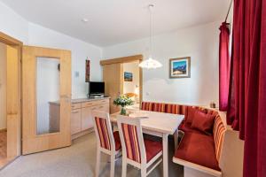 a kitchen and dining room with a table and chairs at Ferienwohnung Helena in Schwendau