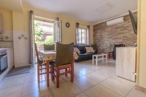 a kitchen and living room with a couch and a table at Casa a 100 mt Dal Mare in SantʼAlessio Siculo