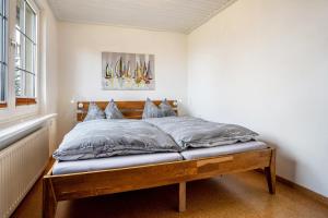a bedroom with a bed with a wooden frame at Ferienwohnung Kropp in Knorrendorf