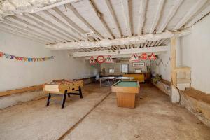 an empty room with ping pong tables in it at Chambres D'hôtes - Le Marlas in Rieucros