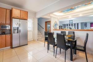 a kitchen and dining room with a table and chairs at Rafaela's House 2 in Koskinou