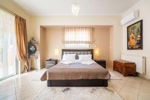 a bedroom with a large bed in a room at Rafaela's House 2 in Koskinou +27 photos