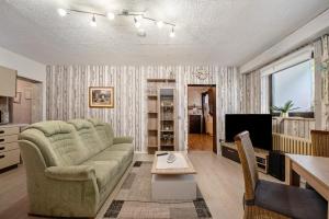 a living room with a couch and a table at Ferienwohnung in der Eifel in Pesch
