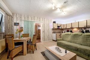 a living room with a couch and a table at Ferienwohnung in der Eifel in Pesch