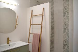 a bathroom with a towel ladder and a sink at Agde Heritage, No. 16 in Agde