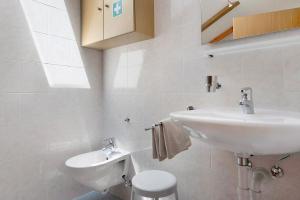 a white bathroom with a sink and a toilet at Stinerhof Panoramablick in Vols am Schlern +22 photos