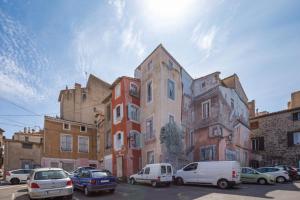a group of cars parked in front of a building at Agde Heritage, No. 16 in Agde