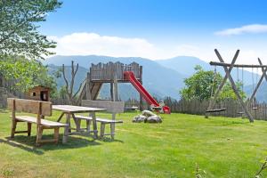 a park with a picnic table and a playground at Stinerhof Panoramablick in Vols am Schlern