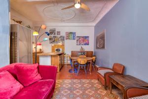 a living room with a red couch and a table at Agde Heritage, No. 16 in Agde